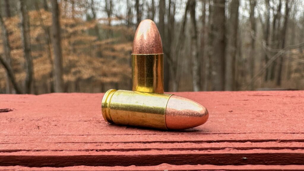 two 9mm FMJ cartridges on a platform
