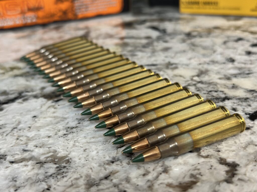 green tip 556 nato cartridges on a counter