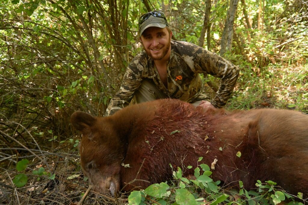 hunter with color phased black bear