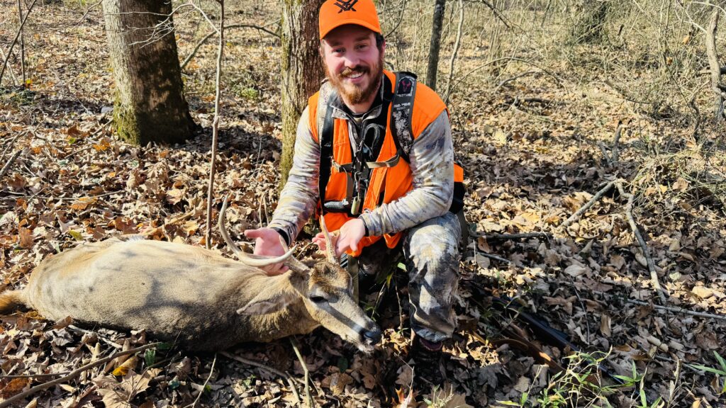 man with whitetail deer