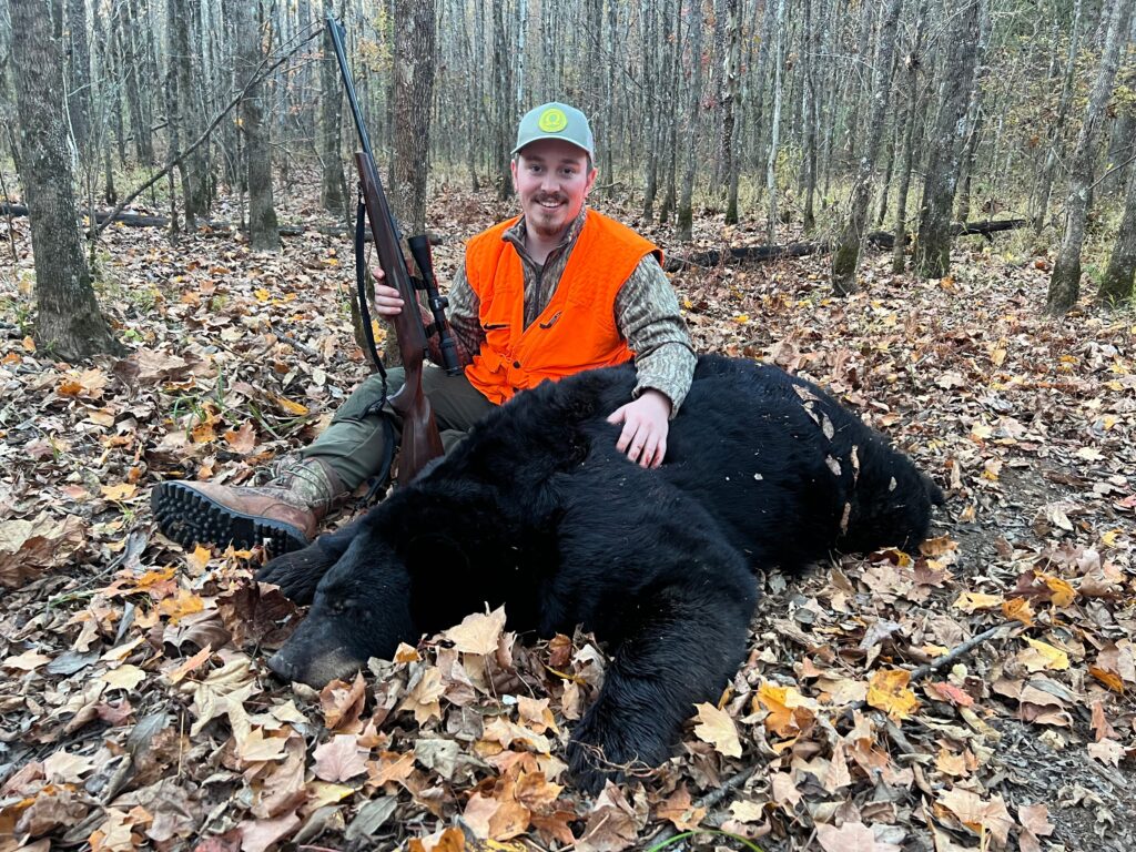 man with black bear