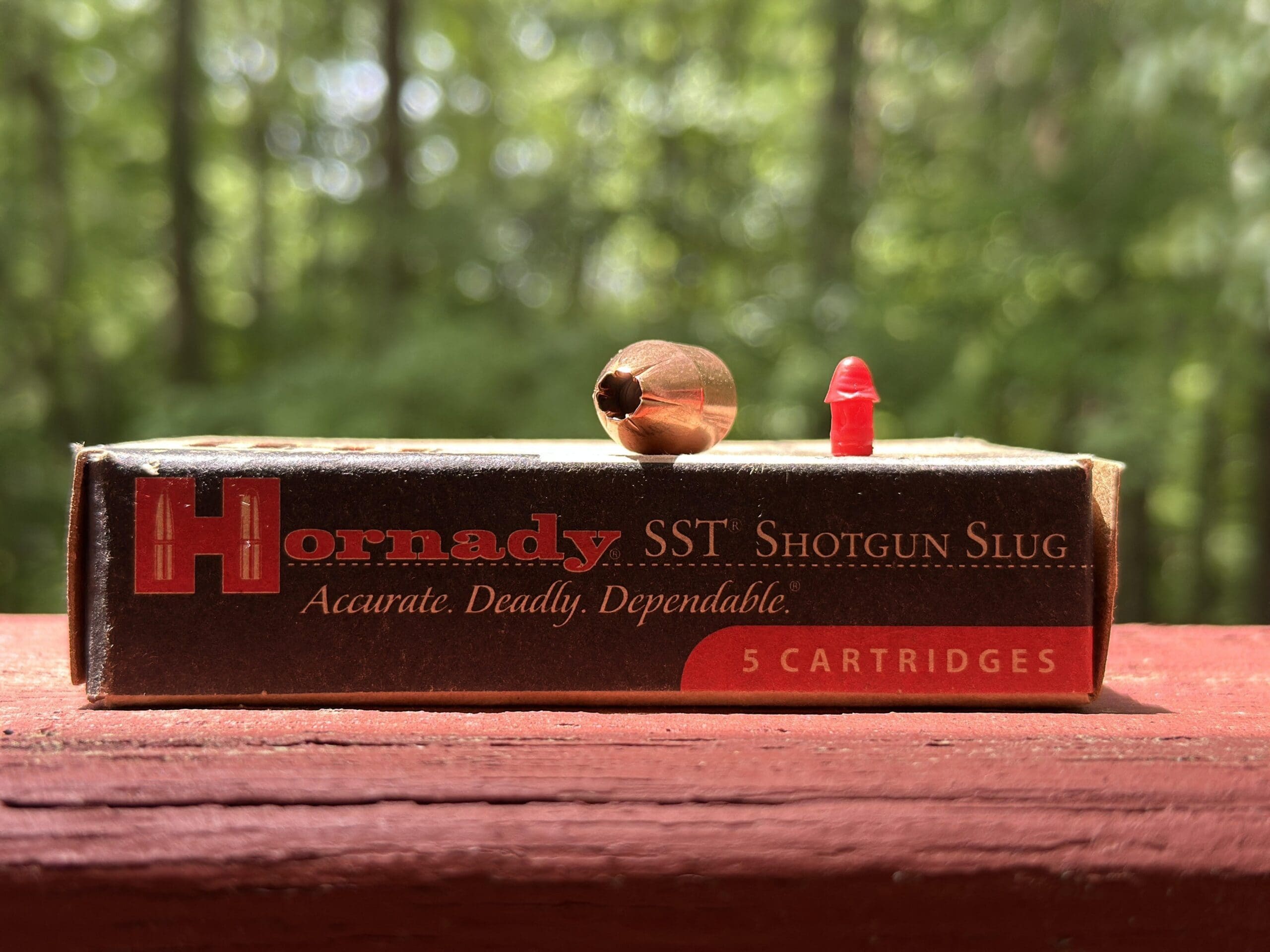 Hornady shotgun slug box beside an expanded slug
